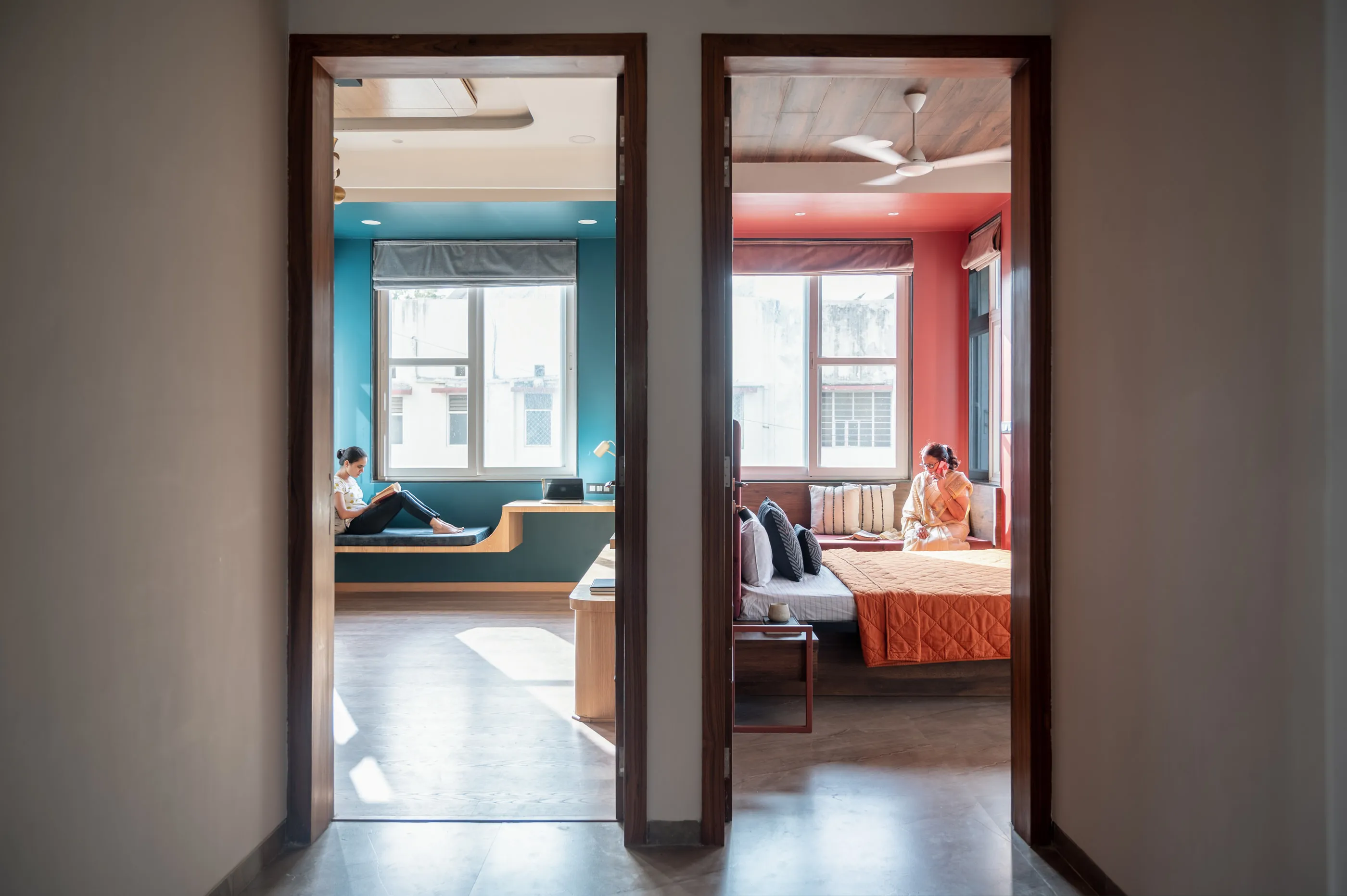 Two doorways opening into a teal and a red bedroom