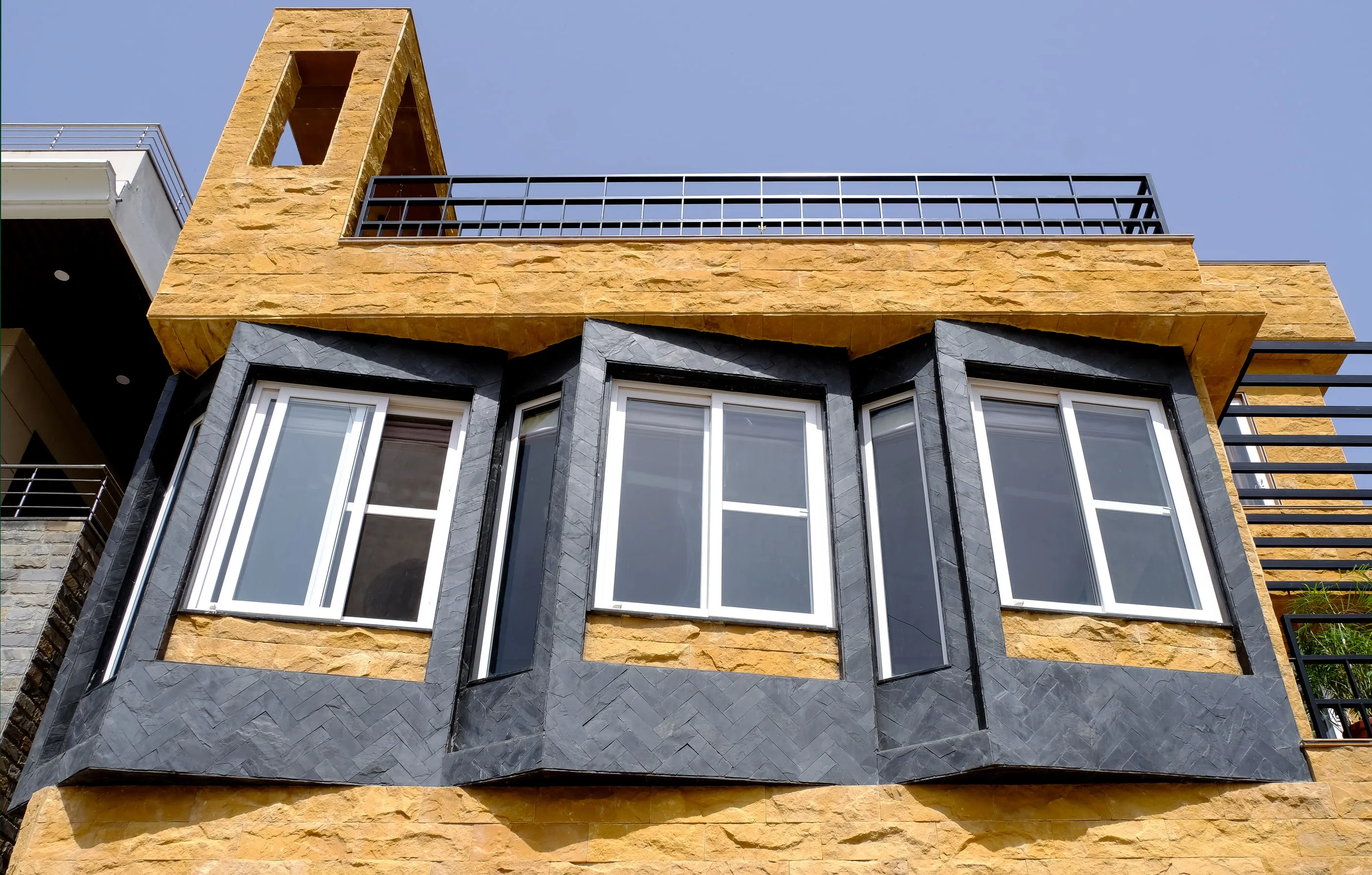 Skewed living room windows framed in black granite