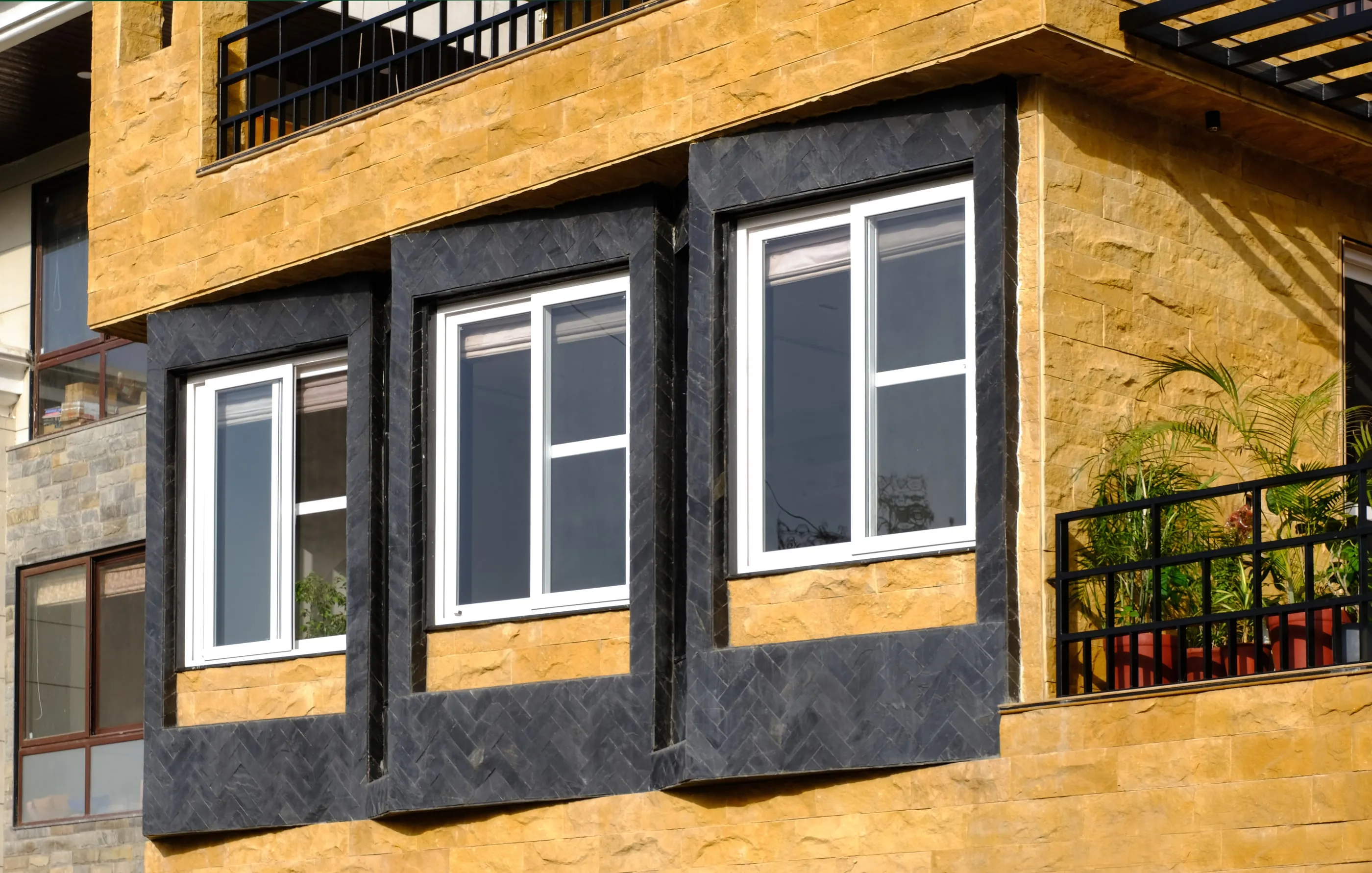 Stone facade with black granite window frames